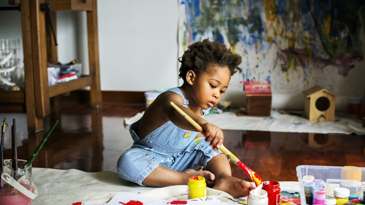 black toddler playing with paint 