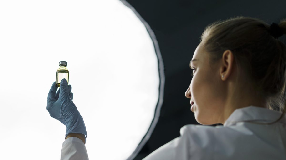 Scientist holding up vial of stem cells. 