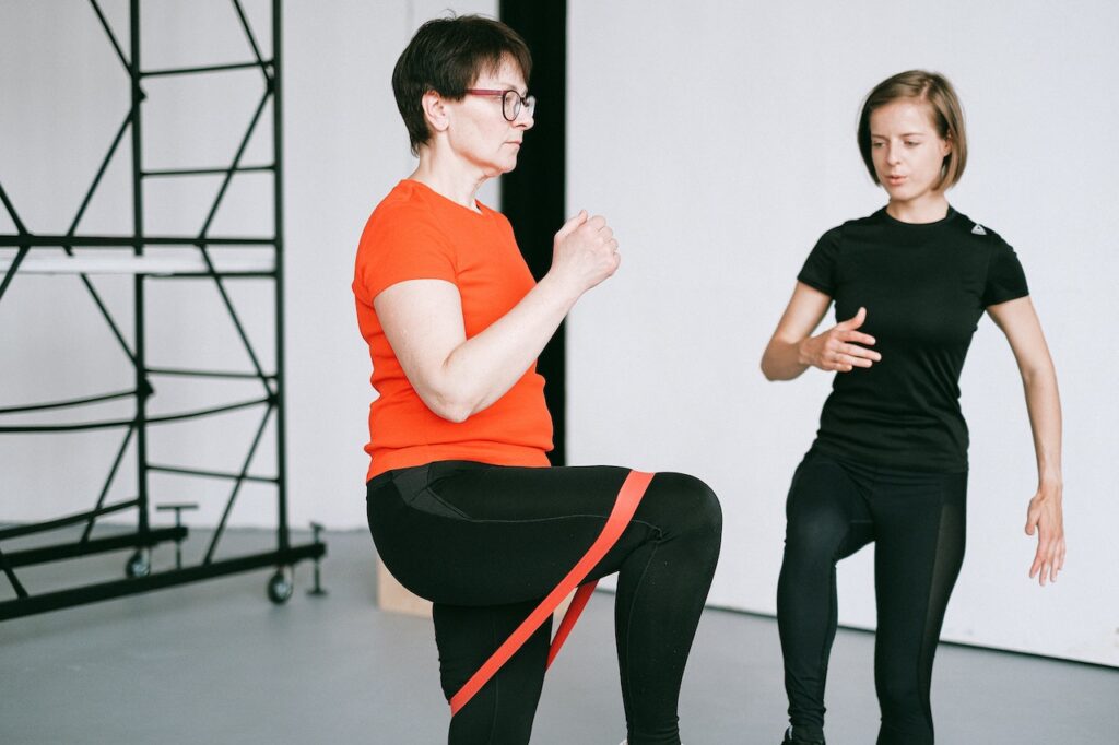 Physical therapist assisting patient with resistance‑band exercises