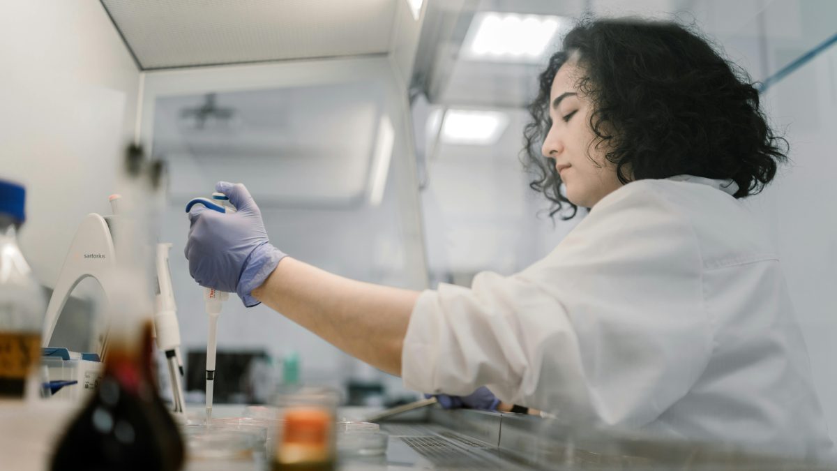 Female scientest handling a sample in a laboratory. 